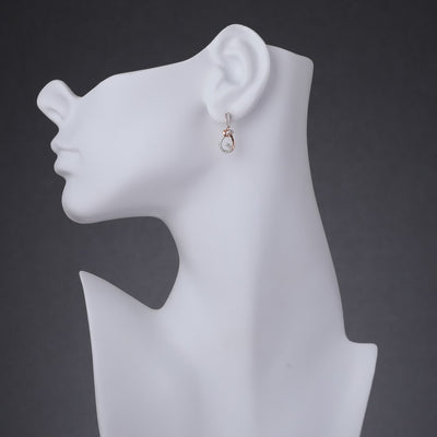 Sterling Silver Simulated Diamonds Knot Rose Tone Dangle Drop Earrings Se9074 on a model