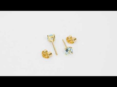 Video of 4mm Round Aquamarine Solitaire Stud Earrings in 14K Yellow Gold.  Includes a Peora gift box. Free shipping, 45-day returns, authenticity guaranteed. E19332
